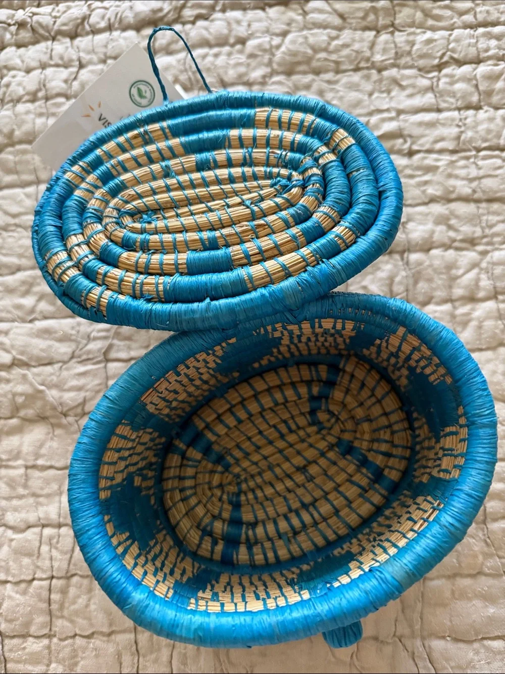 Handmade turquoise and tan coveted basket from Uganda clasp in the front